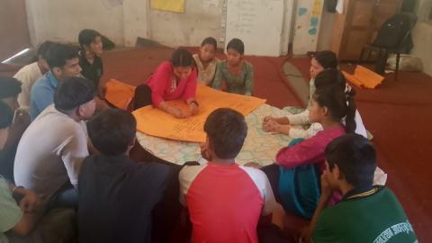 Pratiksha participates in an SRGBV orientation at the community level, requested by adolescents, and takes the lead in a group activity.