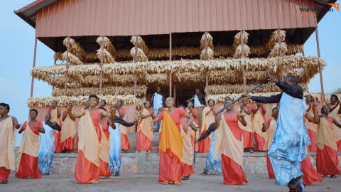 ‘Inyamamare’ Troupe supported by World Vision, behind them is the maize drying shade were they keep their maize