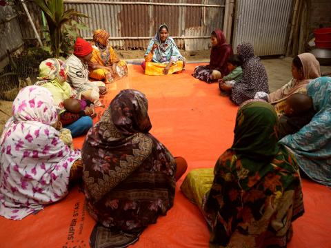 Sufia leading a community discussion with local women and children to address child marriage and school dropouts.