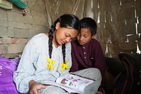 Asta supports her brother with his homework in their Jhyauli. (© 2026 World Vision International Nepal/Deepshikha Shrestha)