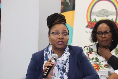 A woman holding a microphone.