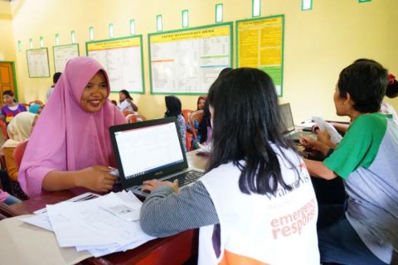 Asfiani holding her proof of identity, a requirement for participation in the social protection programme's multipurpose cash assistance project in Central Sulawesi