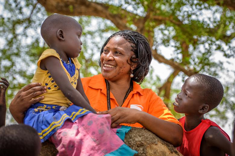 A World Vision employee with local children