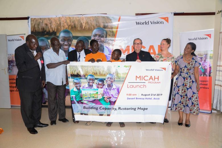 World Vision Uganda National Director, Jason Evans, Refugee Response Director, Jennifer Neelsen, and Arua District Resident District Commissioner (RDC), Nahori Oya (Guest of honour) , and some children beneficiaries officially launching the MICAH program in Arua.