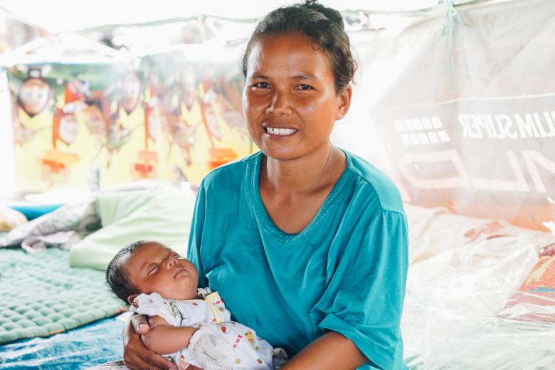 Indonesian mother holding two month old baby