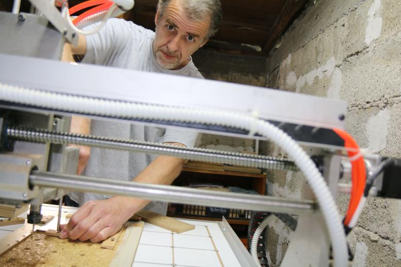 Amir is working with the carpentry computer numeric control (CNS) machine he received as a donation.