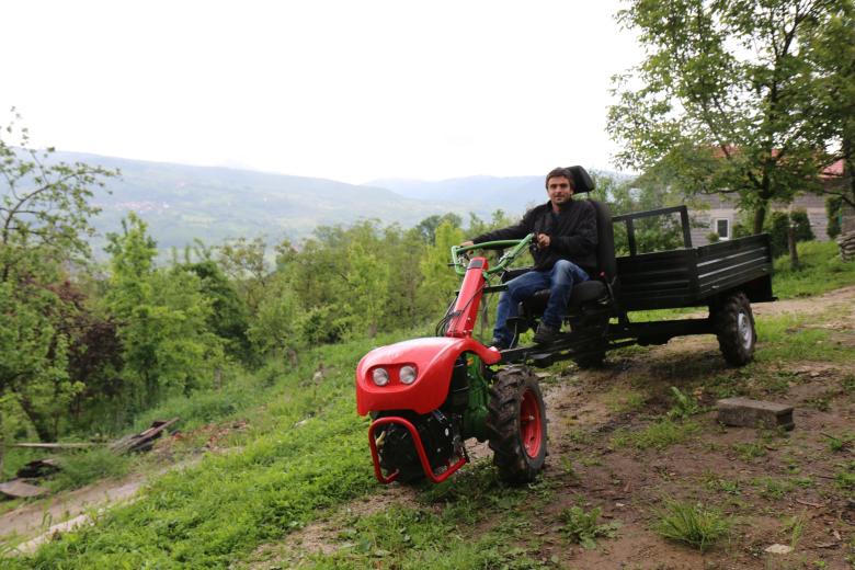 Survivor of a landmine accident, Abid rides the motor cultivator received as a donation trough the „Integrated socio-economic help to the mine victims“ project.