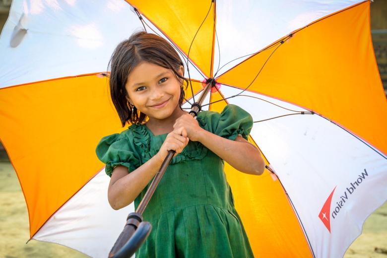 Rohingya refugee girl with World Vision umbrella