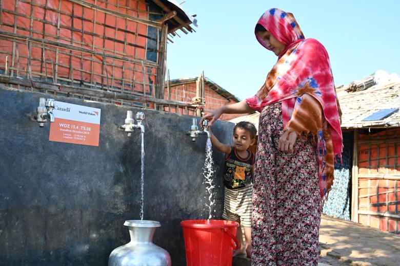 Shahanara, a Rohingya mother of three children, collects water from one of 30 water points in Camp 15 that provide chlorinated potable water to more than1,000 refugee and host community families. World Vision installed the innovative solar-powered water network, funded by Global Affairs Canada. Photo: Himaloy Joseph Mree, World Vision