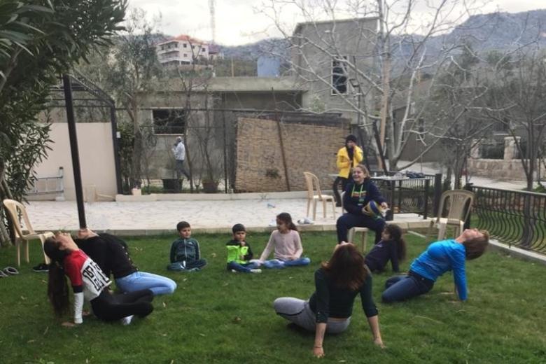 Elise doing Yoga with her family