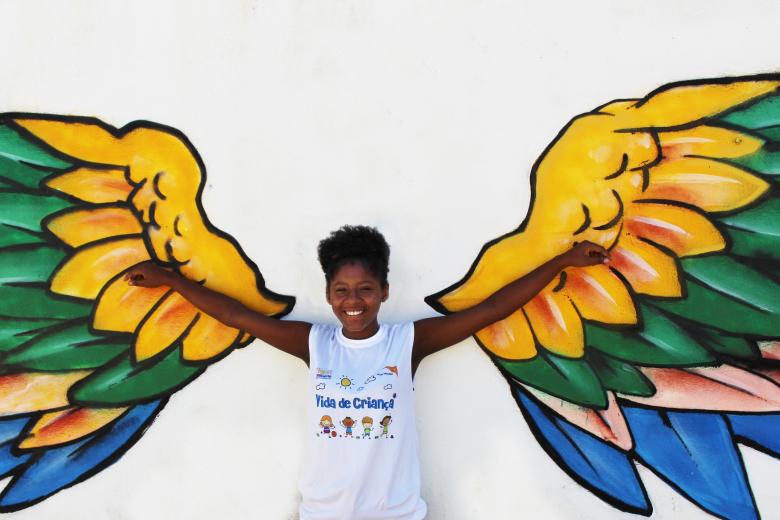 Girl with outstretched arms and wings