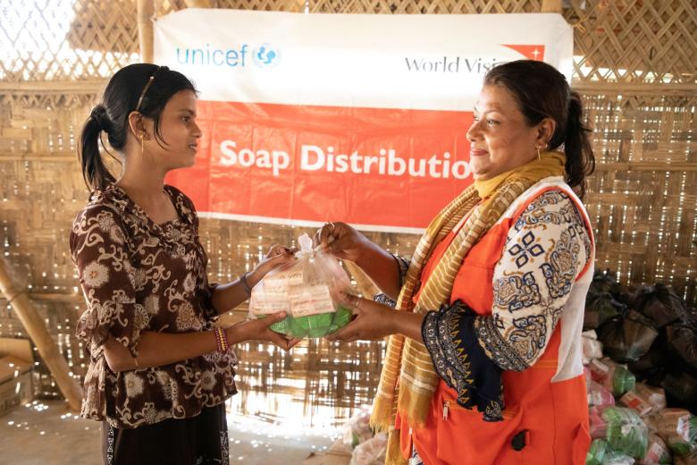 A child receives soap from a World Vision staffer