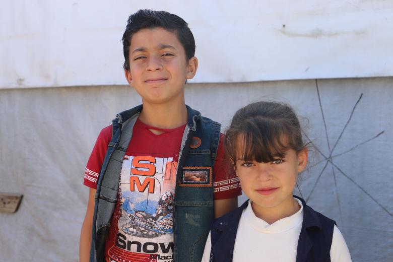Hussein standing next to his sister Hanaa