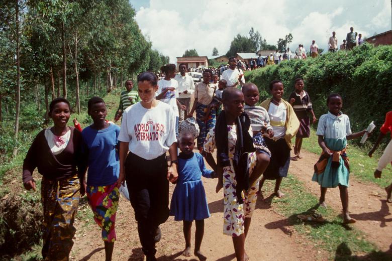 World vision Staff and Hidden Hero walks with displaced children