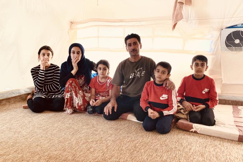 Dakheel and his family in their tent at Bardarash Camp