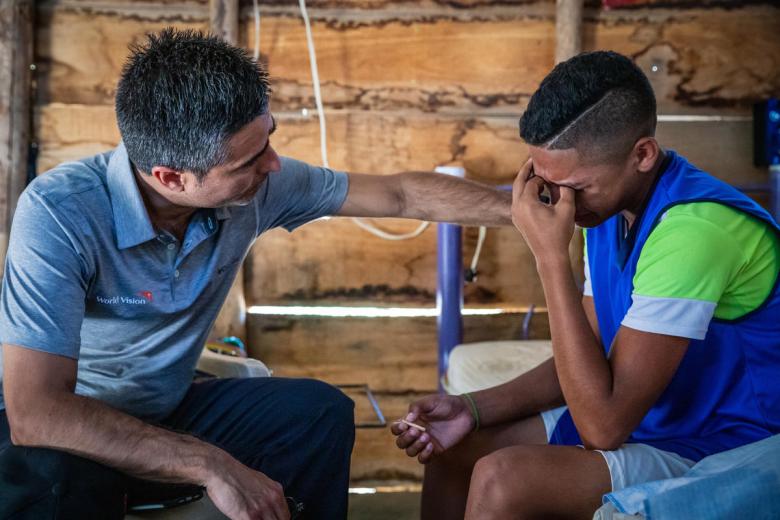 Venezuela refugee with world vision staff in Colombia