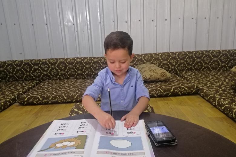 Five-year-old Qutaibah, a participant in our ECD programme at Azraq Refugee Camp is studying remotely due to COVID-19 lockdown