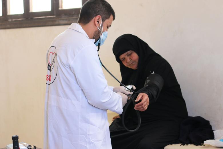 Balsam getting checked by the medical mobile unit's doctor in North-West Syria