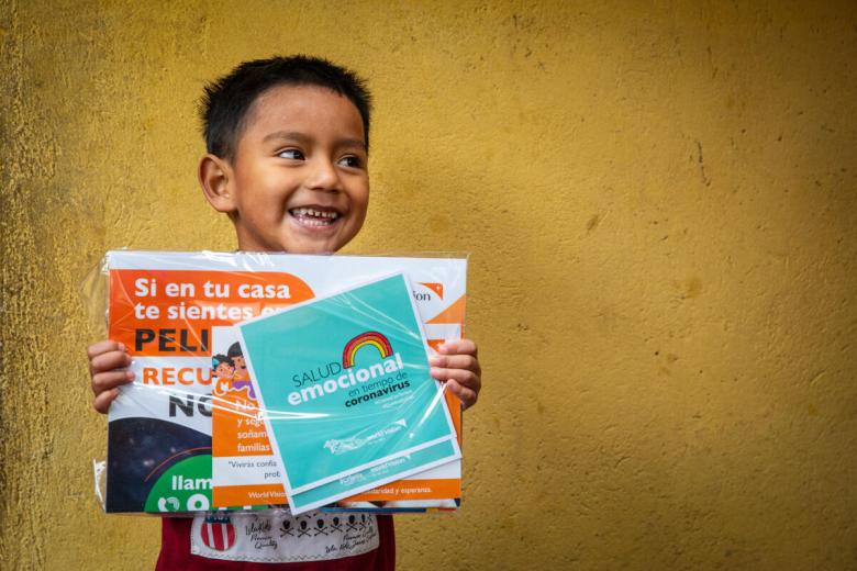 Boy in Ecuador with educational materials