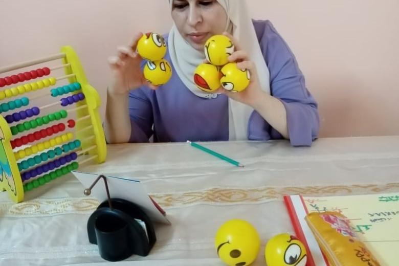Safaa, the Maths teacher, is using small balls to explain the addition lesson properly. The teacher is using variable teaching and learning materials to attract the students’ attention.