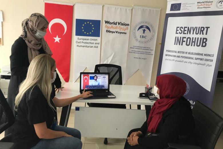 Refugees watching informative videos at IBC's info hub
