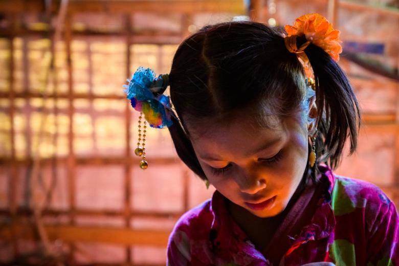 A Rohingya refugee girl with had bowed