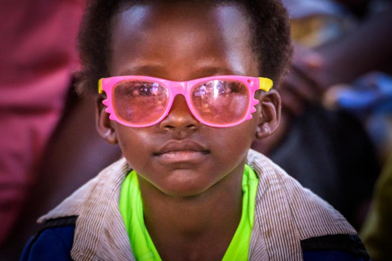 Child in pink glasses