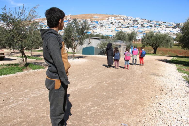 Syrian boy looks over his new home