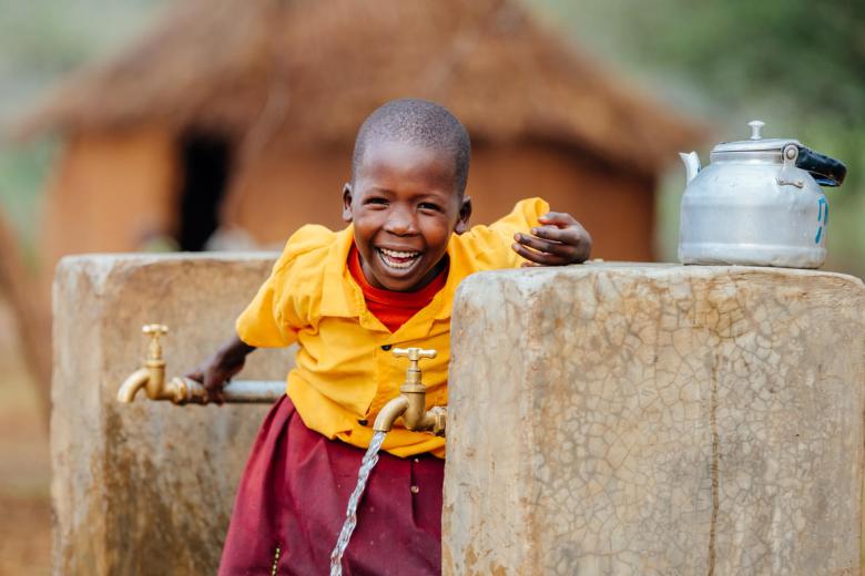Cheru at water tap with clean water