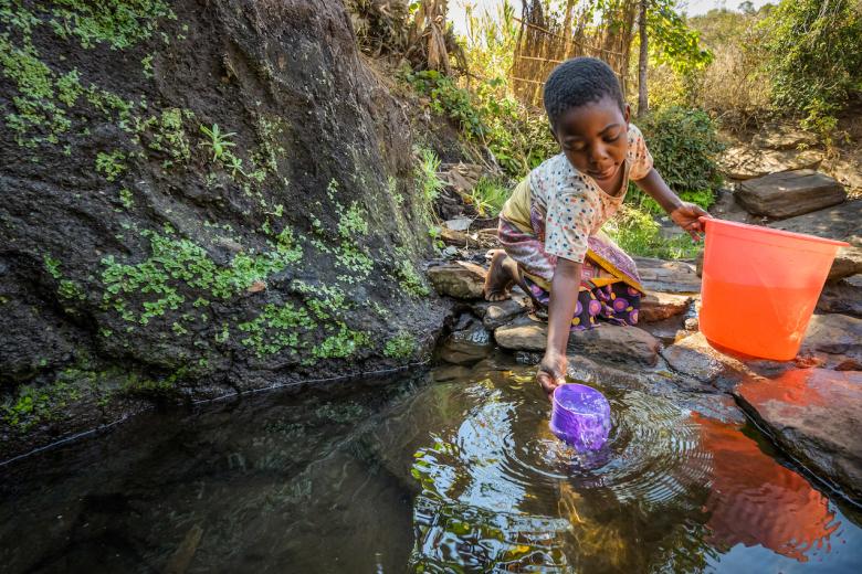 Irene collecting water from a stream in Malawi