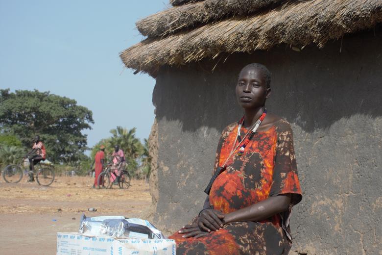 Woman sitting outside a hut in South Sudan