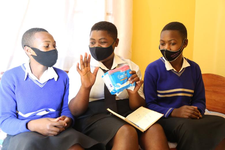 Girls chatting while in their safe space at the menstrual hygiene room