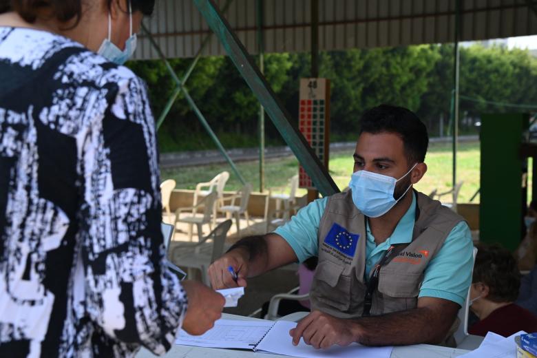 staff handing a paper