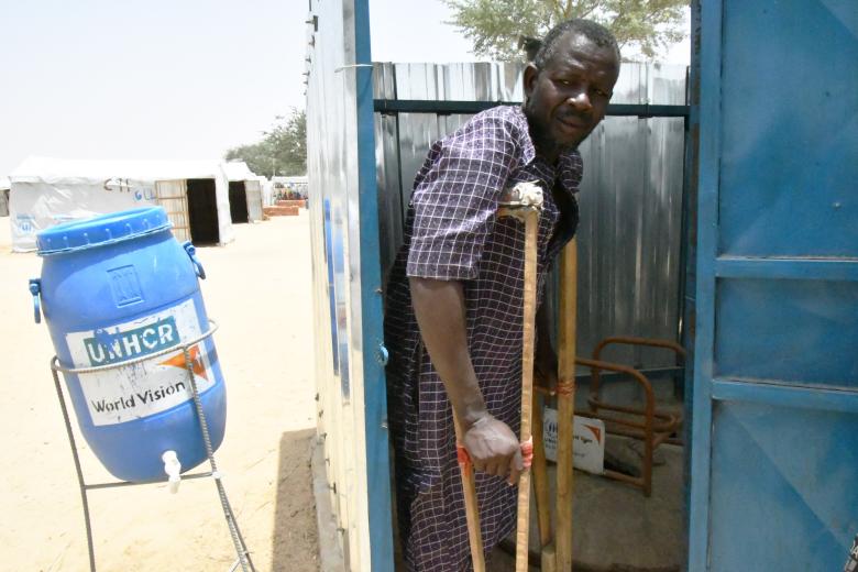 Adamou in the latrine equipped with a chair
