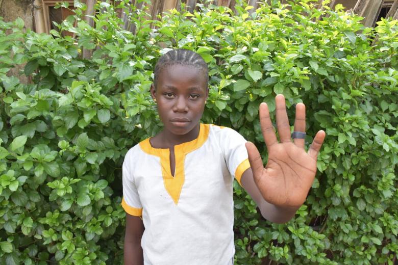 Girl holds her hand out against child marriage