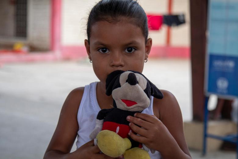 Ami and her Mickey Mouse toy fled Venezuela to the Ecuadorian border with Peru.