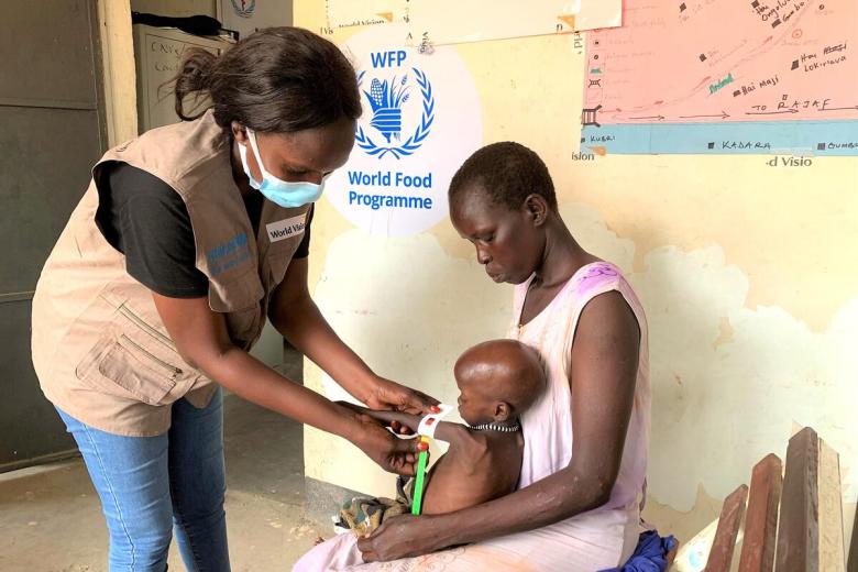 Child having upper arm circumfrance measured to determin state of malnutrition in South Sudan