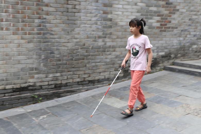 Xiaobing can walk unaided now with her skills training.