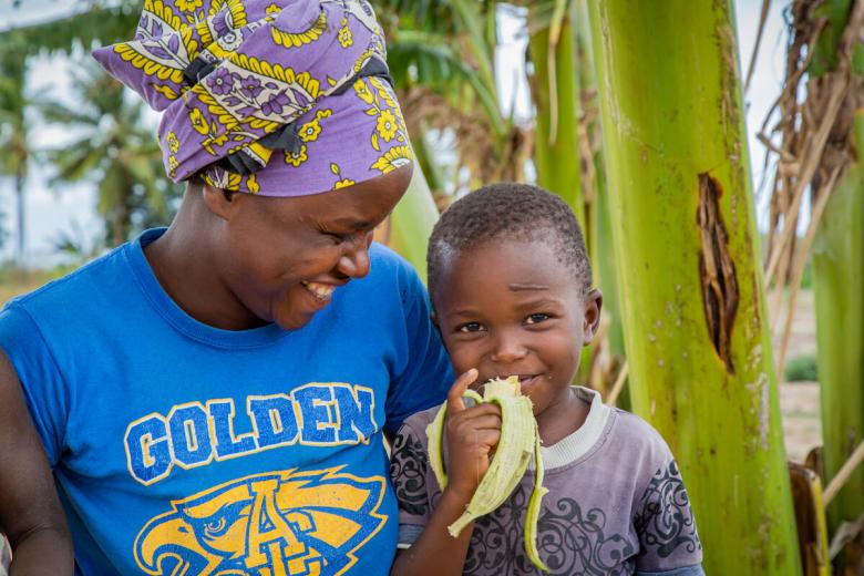 Sponsored child enjoys a banana thanks to kitchen gardens in Kenya