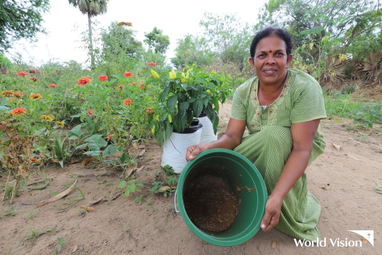 A woman in Sri Lanka shows her harvest