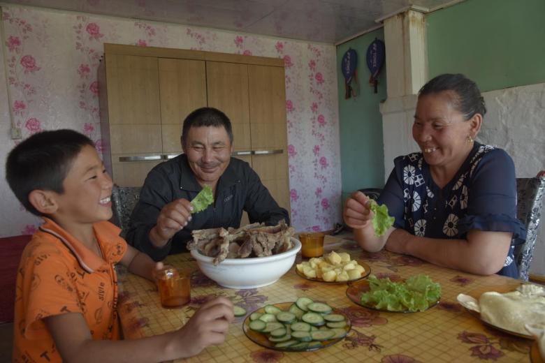 Sponsored child Otgonnyam eats with family.