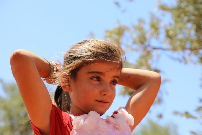 Syria girl against a blue sky