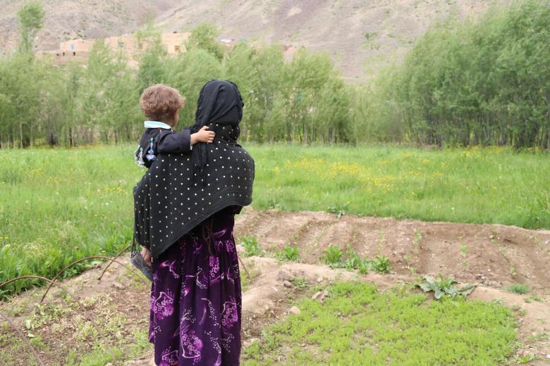 Woman in Afghanistan holds baby