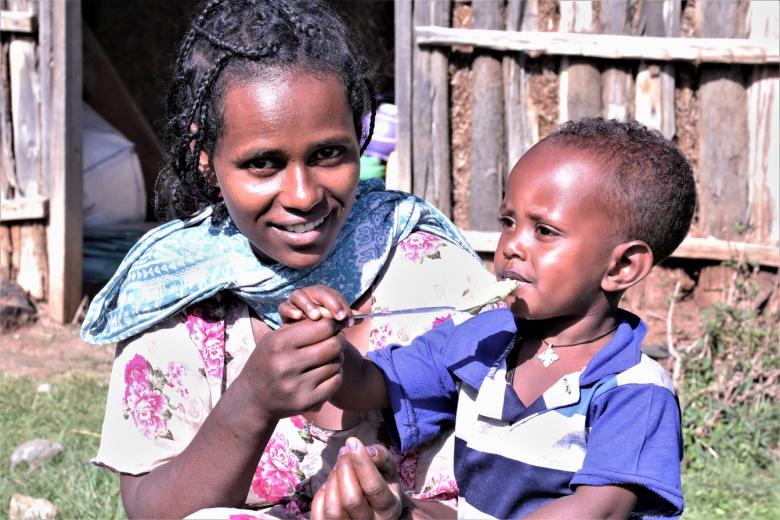 Emebet Feeds her son nutritious food