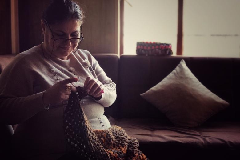 Montaha knitting In her home
