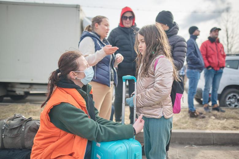 Ukrainian refugee girl with World Vision staff