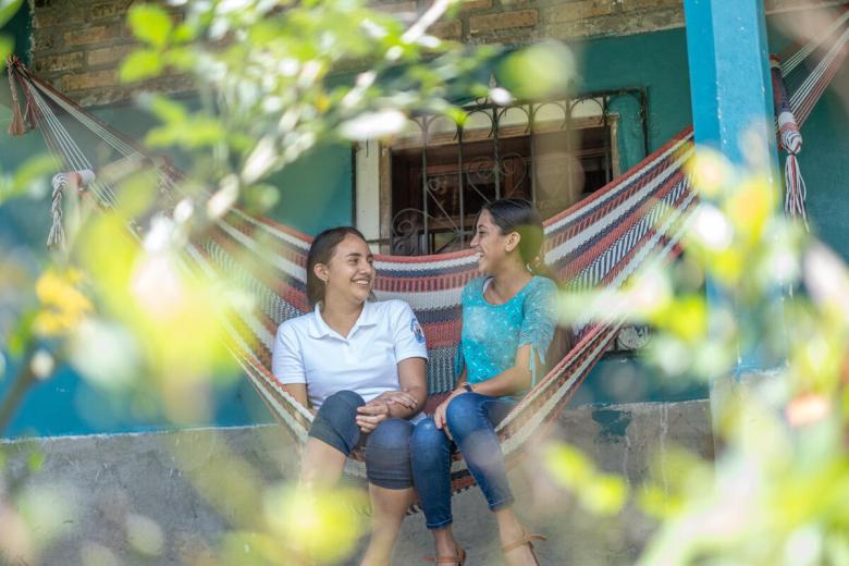 Danesi sits in a hammock with a friend
