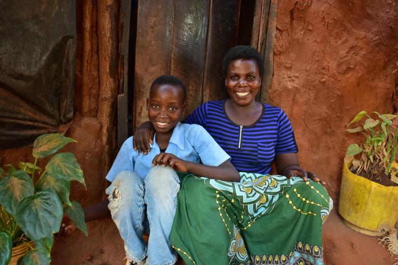 Mother and son sit on porch