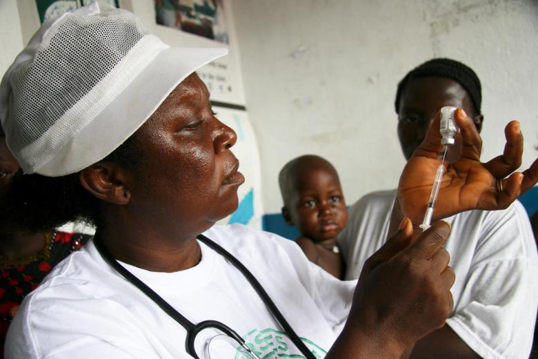 Nurse Sando Fisher prepares an injection at a World Vision supported clinic in Bagbo ADP Sierra Leone
