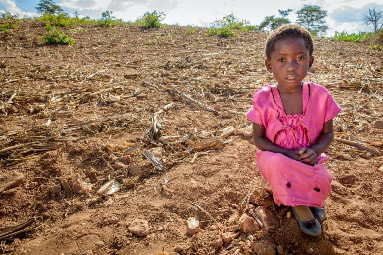 Ruth Makala stands in the gate to her family's garden.